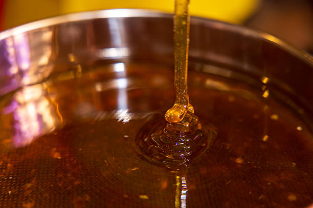 istock Honey stream into container stock photo 2231377261
