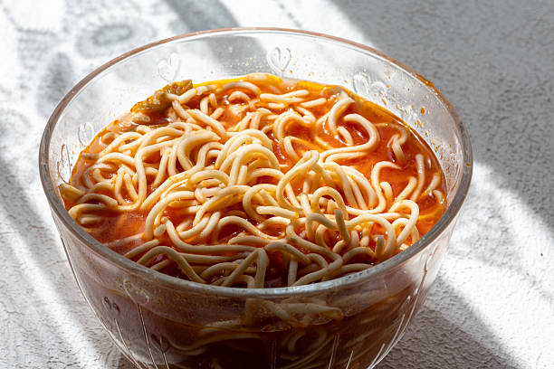 ramen soup noodles with tomato sauce in a bowl