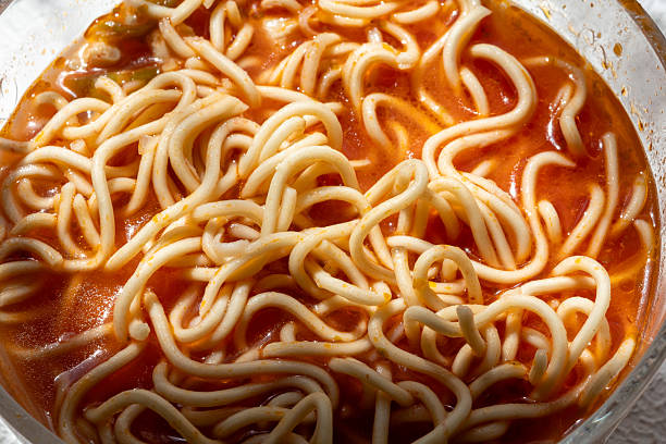 ramen soup noodles with tomato sauce in a bowl