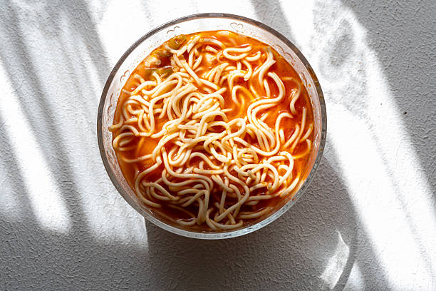 ramen soup noodles with tomato sauce in a bowl