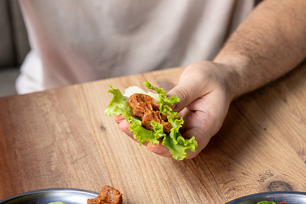 istock Making raw meatballs ( Turkish: Cig Kofte ) on wooden background 2231377483