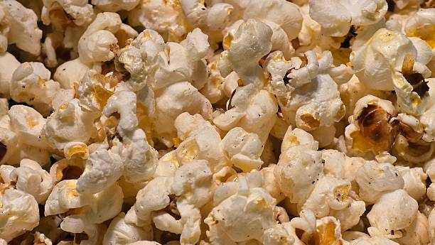 istock A large quantity of popcorn is shown in a close-up shot, with some kernels having a slightly darker, buttered appearance. 2231380189