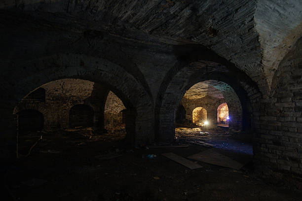 istock Dark and creepy vaulted red brick dungeon 2231381634