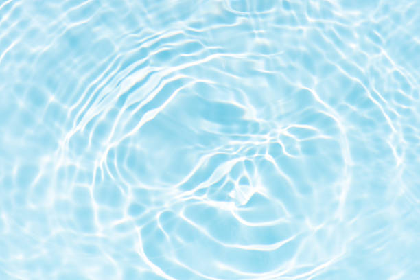 istock Blue water with ripples on the surface. Defocus blurred transparent blue colored clear calm water surface texture with splashes and bubbles. Water waves with shining pattern texture background. 2231382899