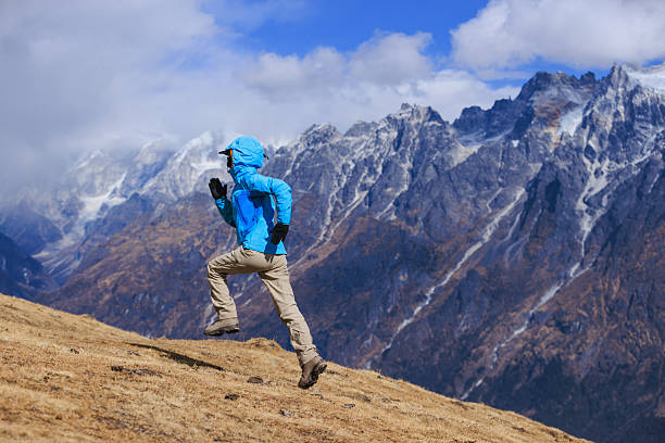 istock Woman trail runner running in grassland 2231383030