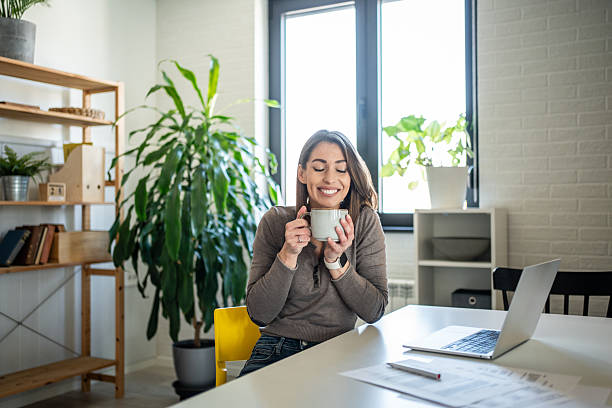 istock Young woman enjoying a coffee break at home office 2231384705