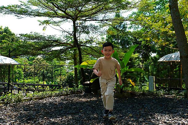 Smiling child in motion while running outdoors
