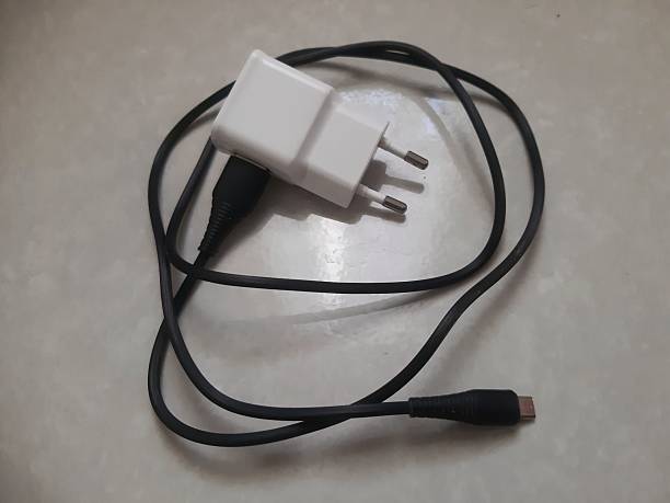 istock Mobile phone charger with black cable on floor 2231389210