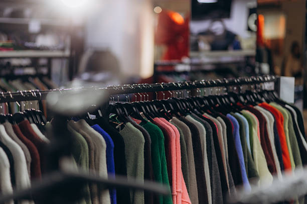 istock Clothing Rack Displaying Casual Sweaters in Various Colors Inside a Modern Store 2231391224