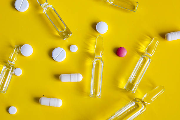 istock Chaotically scattered ampoules, tablets, and capsules on a bright background symbolize modern medicine and the pharmaceutical industry. 2231391581