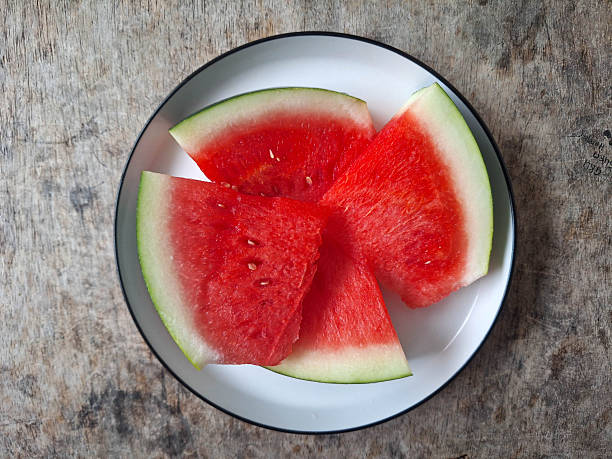 Two slices of watermelon on a white background. Studio photography on a white background.