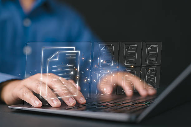 istock Businessman uses a laptop to manage documents management concept digital document online document database and digital file storage systems, record keeping software database technology 2231395360