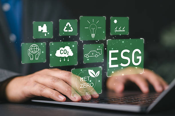 istock Businessman sitting using a computer to analyze ESG, environment, conservation, society, governance, close to the computer screen in business investment strategy concept. 2231395368