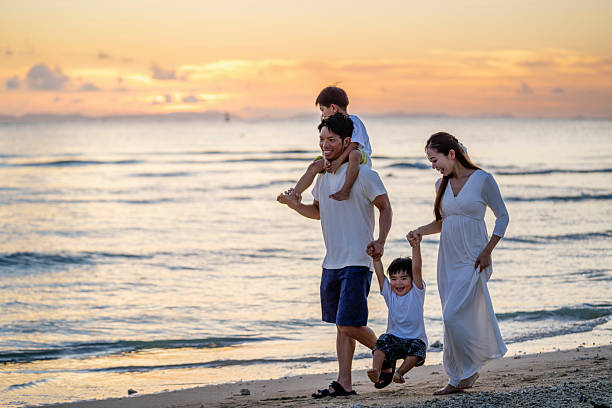 istock Family walking on the beach at sunset. 2231395664