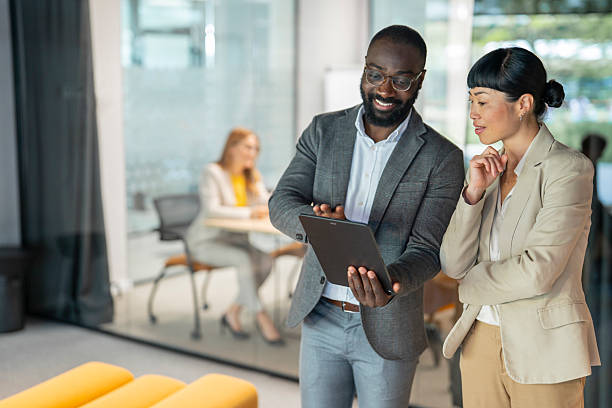 istock Business colleagues collaborating on digital tablet in modern office 2231399733