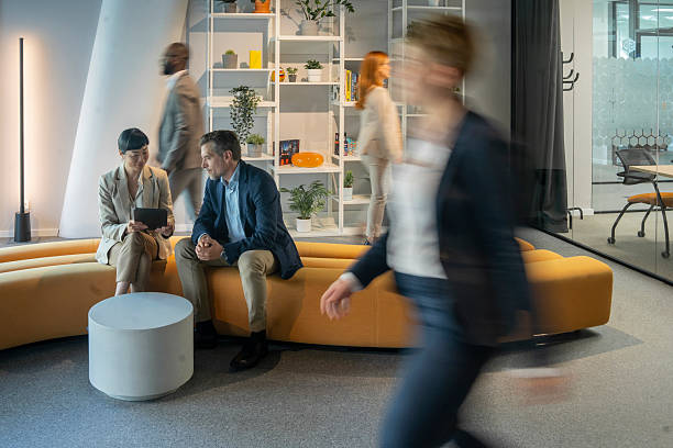 istock Business people discussing work in modern office lobby 2231399789