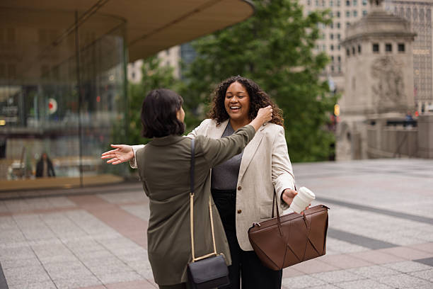 istock Two businesswomen hugging in Chicago 2231400262