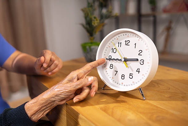 istock Asian Elderly Woman with Dementia Practicing Read Time on Clock. 2231405947