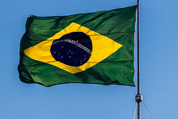 istock Brazilian flag waving against a clear blue sky 2231409711