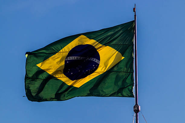 istock Brazilian flag waving against a clear blue sky 2231409712