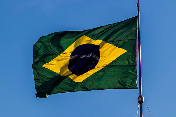 istock Brazilian flag waving against a clear blue sky 2231409719