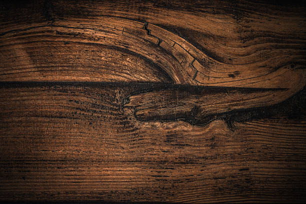 Detailed photo showcasing the texture and grain of a wooden surface, emphasising its natural patterns and rustic feel. Ideal for backgrounds, design projects, and material-oriented concepts.