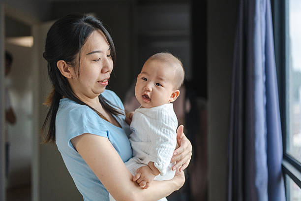 istock Nestled in Morning Light: A Mother’s Touch Begins the Day 2231413355