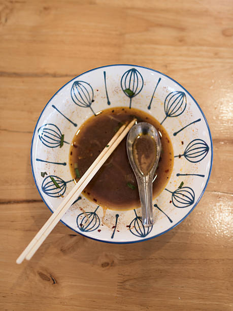 istock Empty Noodle Soup Bowl with Chopsticks and Spoon on Wooden Table – Overhead View 2231413445
