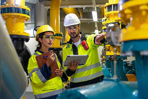 istock Hispanic workers examine HVAC equipment, ensuring efficient heating and cooling in a modern manufacturing plant. 2231413549