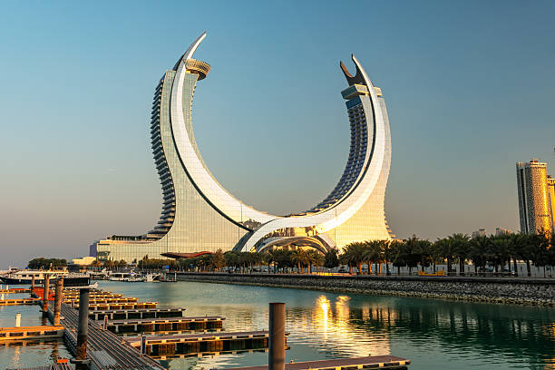 Doha, Lusail city, Qatar - February 1, 2025: Crescent tower from Al Maha Island in Qatar, with a brightly colored sky before sunset