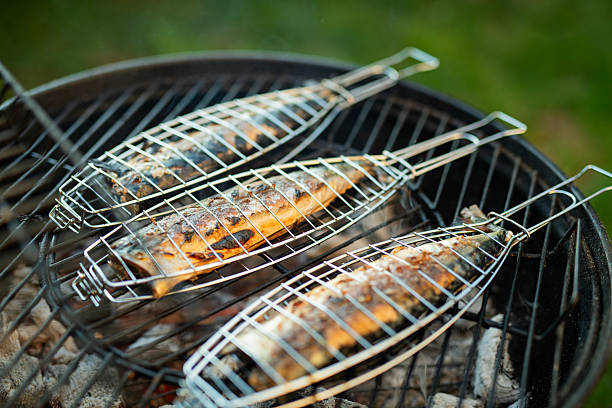 Close-up of fish grilling on a BBQ.