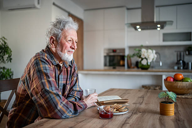 istock Senior man enjoying breakfast and contemplating in his kitchen 2231418066