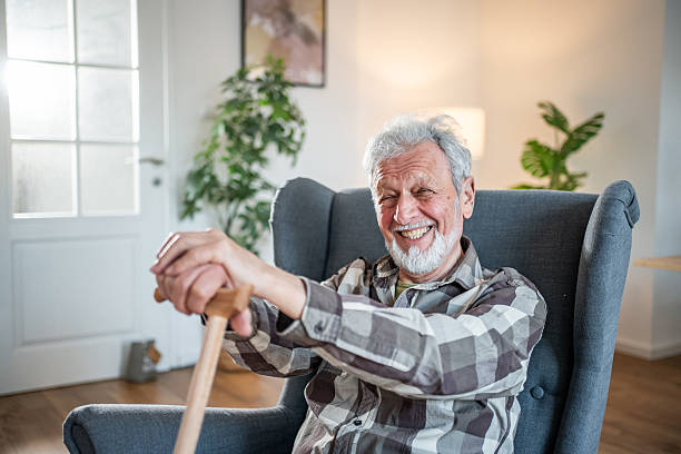 istock Happy senior man smiling and holding a walking cane 2231418551