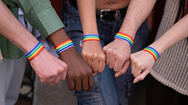 istock Activists showing support for lgbtq+ rights with rainbow bracelets 2231419056