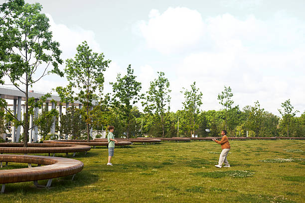 Two children playing catch with ball on grassy field surrounded by trees, one Caucasian boy throwing ball while other child preparing to catch