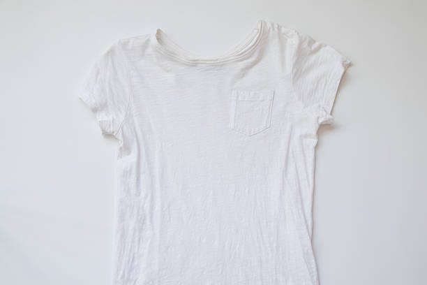 istock White short sleeve t-shirt lying on white surface, minimalist style, clean background for mockup or template 2231422385