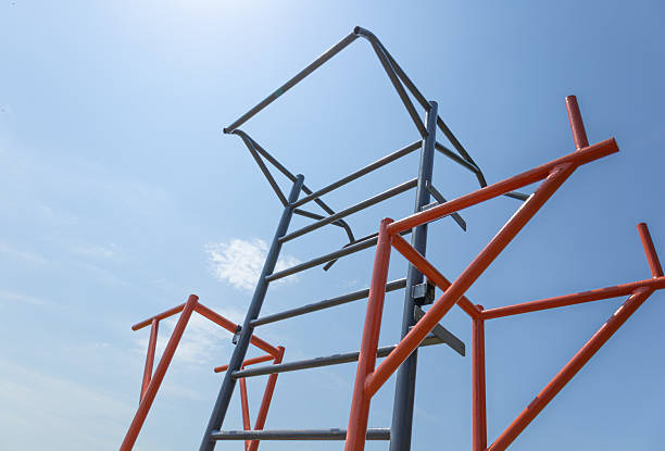 istock A tall metal structure is set against a clear blue sky, inviting children to play and explore on a sunny day in a park 2231422772