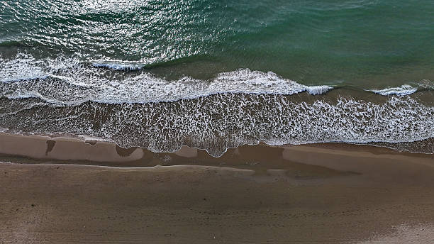 istock Gentle waves caress the shore under a bright sky on a tranquil coastal escape 2231430013