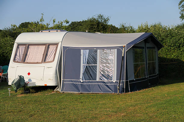 istock Ready for summer, caravan with a large awning doubling its size parked on Caravan Park in shelter of hedgerow on a summers day, in rural UK a popular holiday for many British families. 2231430168