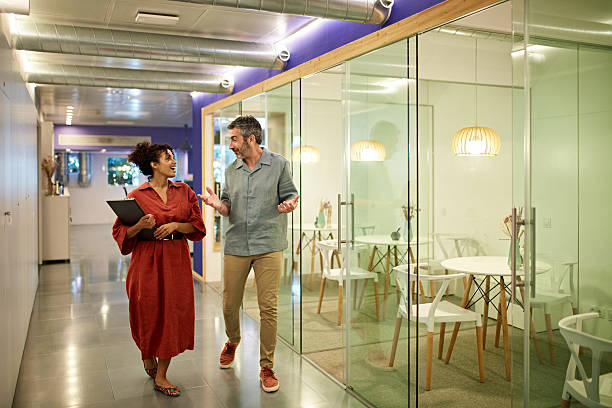 istock Colleagues enjoying face to face conversation in office 2231430305