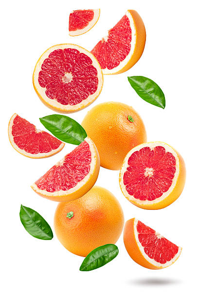 istock grapefruit with slices and green leaves isolated on white background. clipping path 2231430671