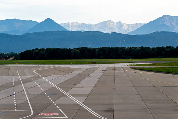istock Empty Airport Runway with Mountain Backdrop on a Clear Day 2231431042