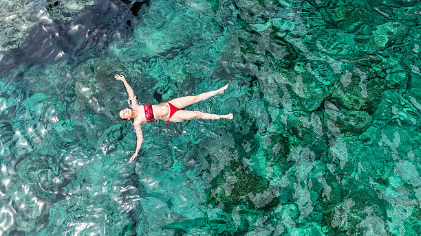 istock Floating effortlessly in crystal clear waters under the radiant sun during a serene summer day in a tropical paradise 2231435189