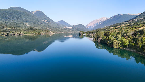 istock Tranquil reflections in a serene lake surrounded by mountains at sunrise 2231435402