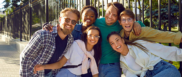 istock Multiracial young people university students dressed in casual clothes with smile stand on sidewalk 2231435722