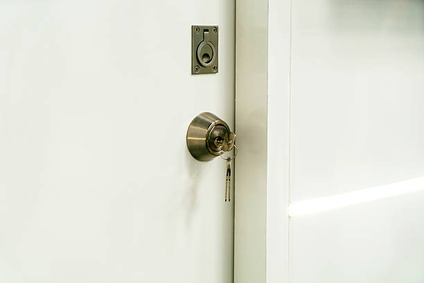 istock Modern Door Lock with Keys on White Surface 2231437920