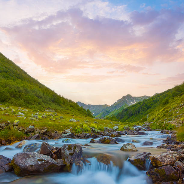 mountain river rushing over a stones, evening mountain scene
