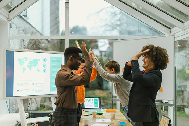 istock Marketing team celebrating successful global project in modern office 2231439429