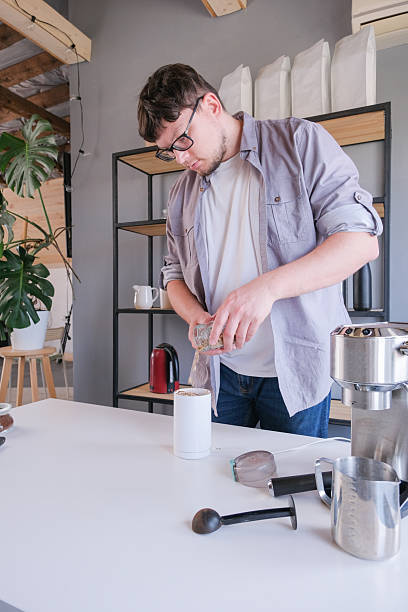 istock young man grinding coffee at home , making coffee in the morning 2231442333