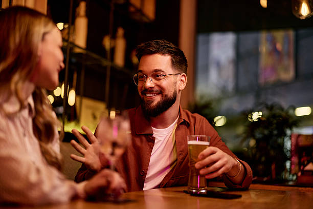 istock Friendly Conversation Between Two People Enjoying Drinks in a Cozy Cafe 2231442800